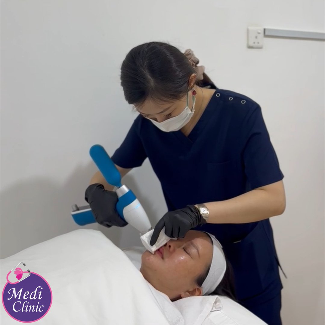 Dr. Fiona carefully documenting patient assessment and creating customized filler treatment plans at JB aesthetic clinic